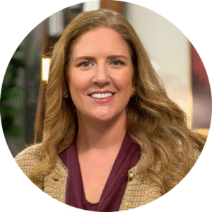 A headshot of a woman with auburn hair.